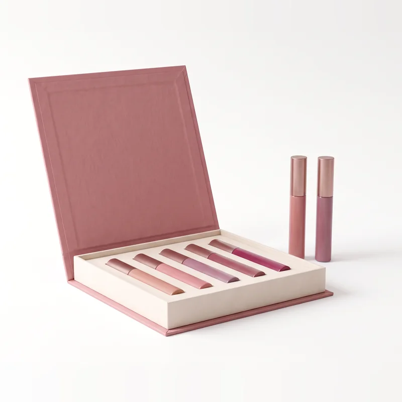 Open dusty rose lip gloss box with two tubes standing beside it