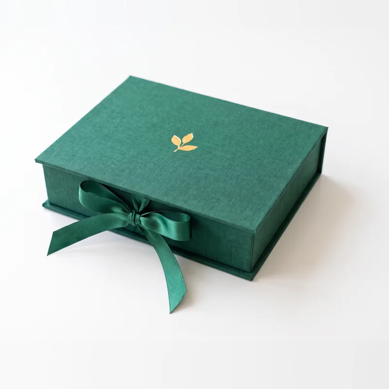 Closed emerald jewelry box tied with a satin ribbon bow