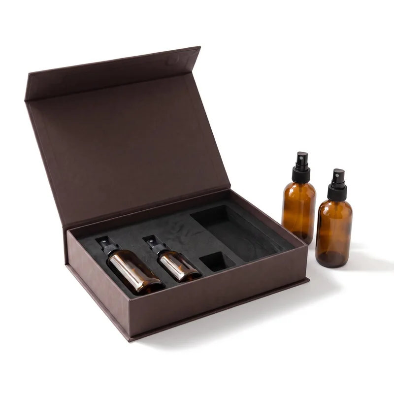 Espresso brown skincare gift box with a black EVA insert and amber spray bottles