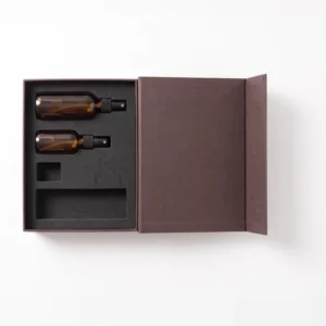 Top view of the black EVA insert holding two amber spray bottles