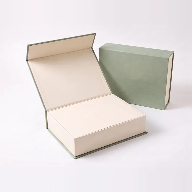 Sage green box open with the ivory inner flaps folded closed